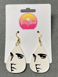 Where are my Elvis fans! If you are looking for some fun and flashy Elvis earrings, you've come to the right place.  All of my earrings are made with nickel free, 925 silver-plated copper earring hooks and they come with silicone safety backs stoppers.  They are handmade with faux leather and vinyl.  The double layer earrings will have plain white faux leather on top and the back layer can be red, gold, silver, green, or blue glitter.  Check out my shop for other Elvis earring designs. Message m David Bowie Earrings, Houston Astros Faux Leather Earrings, Elvis Jewelry, Layer Earrings, Guitar Earrings, Silver Nickel-free Music-themed Earrings, Earring Designs, Green Glitter, Red Glitter