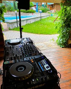 a dj set up in front of a swimming pool