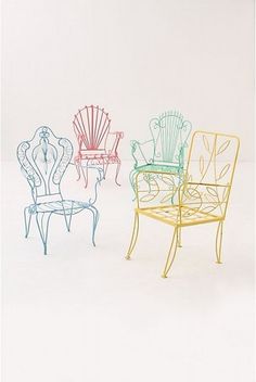 three chairs sitting next to each other in different colors