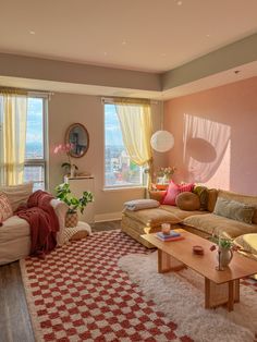 a living room filled with furniture and large windows