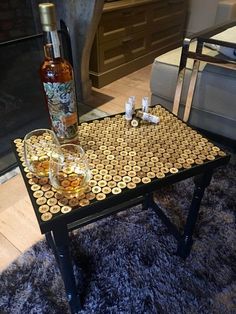 a table with two glasses and a bottle on it