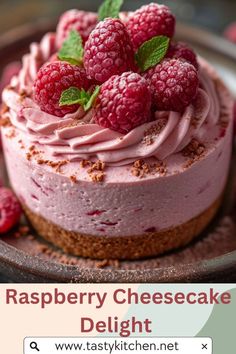 raspberry cheesecake on a plate topped with whipped cream and fresh raspberries