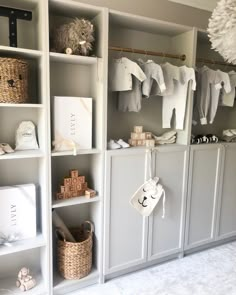 a baby's closet with clothes and toys on shelves