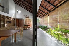 the inside of a house with an open floor plan and large wooden table in front of it