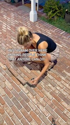 a woman kneeling down on top of a brick floor next to a white post with the words instagram over here making people think that anyone can diy