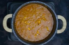 a pot filled with food sitting on top of a stove