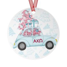 a christmas ornament with a car and presents on it's roof, hanging from a red ribbon