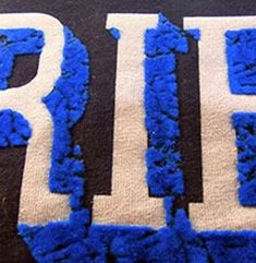 blue and white rug with the word ride written in large letters on top of it