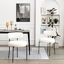 two white chairs and a black table in a room