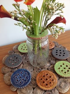 a mason jar filled with buttons and flowers