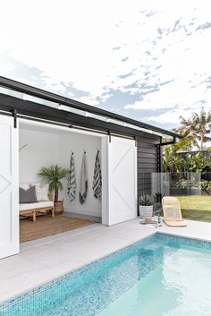 a swimming pool with an open sliding door