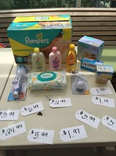 baby products are displayed on a table with price tags and coupons in front of them