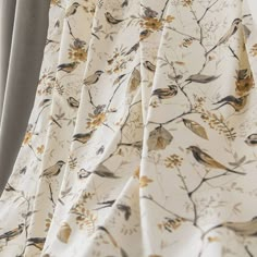 a curtain with birds and flowers on it