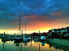 boats are docked in the harbor at sunset