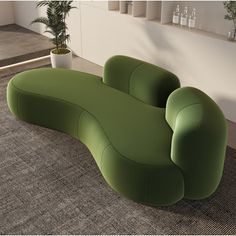 a green couch sitting on top of a rug