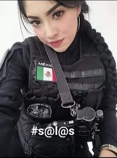 a woman wearing a black vest with mexican flag on the chest and two handcuffs around her neck