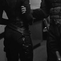 black and white photograph of two people dressed as batman and catwoman in the dark knight movie