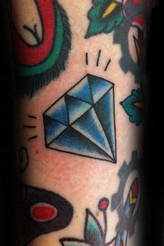 a close up of a person's leg with tattoos on it and an origami design