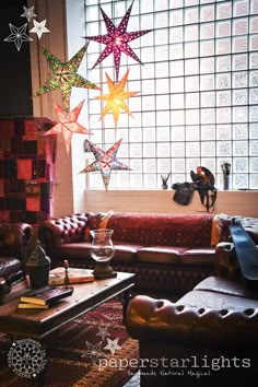 a living room filled with furniture and stars hanging from the ceiling