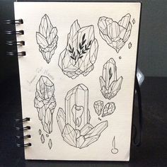 a notebook with drawings of crystals on it