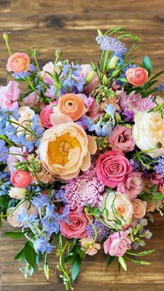 a bouquet of flowers sitting on top of a wooden table