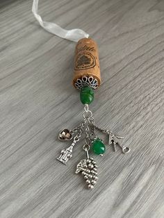 a wine bottle charm with charms attached to it