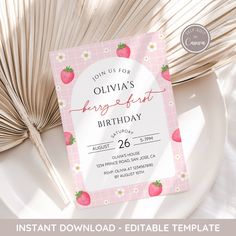 a pink and white birthday party card with strawberries on it, next to an open fan