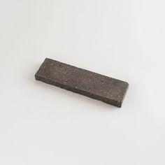 a piece of concrete sitting on top of a white surface