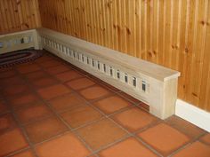 a wooden bench sitting in the corner of a room