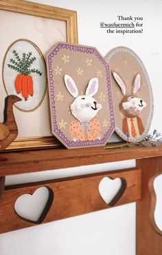 some bunny pictures are on a shelf with hearts