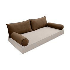 a white and brown couch with pillows on it