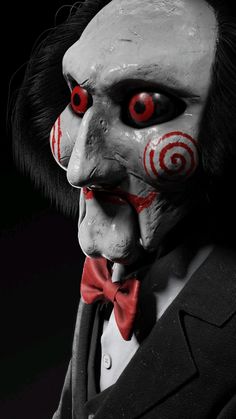 a creepy clown with red eyes and black hair wearing a tuxedo suit in the dark