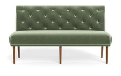 a green couch sitting on top of a wooden frame