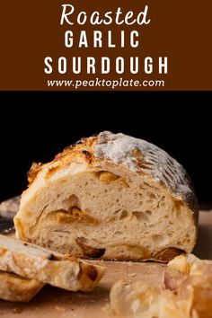 a loaf of bread sitting on top of a cutting board with the words roasted garlic sourdough