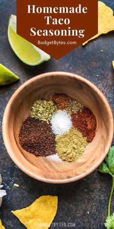 homemade taco seasoning in a bowl with limes and cilantro on the side