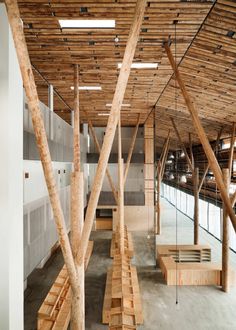 an empty building with wooden beams and benches