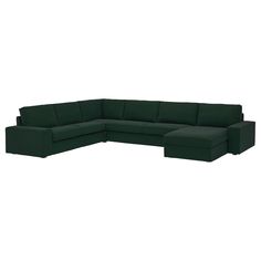 a dark green sectional sofa sitting on top of a white floor