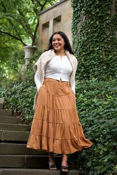 Romantic cottage core inspired vintage maxi tired skirt, the Pumpkin skirt was inspired by past vintage style with a back elastic band along with a five button closure front and belt loops. The Pumpkin skirt features a half slip. 100% Polyester / Half Lined Hand Wash Cold / Line Dry Hidden Side Pockets Fit Notes & Measurements Rosa is 5’6 and wearing a size small XS: 27" length / 25"-27" waist / max 34" hips S: 27.5" length / 27"-29" waist / max 36" hips M: 28" length / 29"-31" waist / max 38" h Cottage Long Skirt, Bohemian Daywear Maxi Skirt With Lining, Bohemian Daywear Lined Maxi Skirt, Fall Tiered Maxi Skirt, Bohemian Gathered Maxi Skirt For Daywear, Casual Fall Maxi Skirt For Daywear, Casual Maxi Skirt For Fall Daywear, Fall Tiered Skirt For Daywear, Casual Tiered Skirt With Buttons