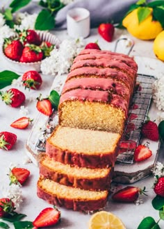 slices of strawberry lemon pound cake on a cooling rack with fresh strawberries and flowers