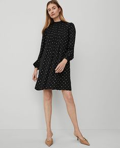 Elevate your wardrobe with the Ann Taylor Diamond Shadows Mock Neck Shift Dress, a perfect blend of elegance and comfort. This dress features a sophisticated mock neck and a flowing shift silhouette that gracefully hits above the knee. Ideal for both office and evening wear, this versatile piece is a must-have for any fashion-forward wardrobe.

- Size: Small
- Color: Black
- Material: 100% Polyester
- Gender: Female
- Neckline: Smocked mock neck
- Sleeves: Long sleeves with shirred caps and elas Shift Dress Long Sleeve, Extra Dresses, Shirred Sleeve, Neck Bracelet, Jackie Dress, Bracelet Sleeve, Mock Neck Dress, Long Sleeve Shift Dress, Usa Dresses