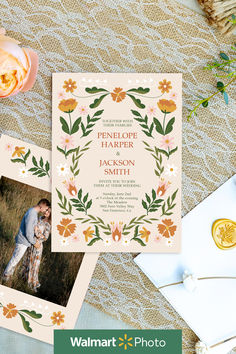 the wedding stationery is displayed on top of a table with flowers and other items