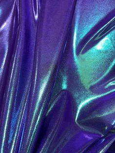 purple and green metallic fabric is shown in close up view, as well as the background