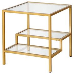 a gold and glass side table with two shelves on each side, against a white background