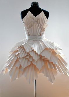 a dress made out of folded paper on a mannequin