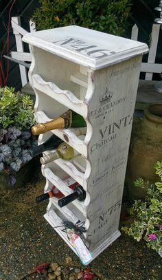 an old wine rack is turned into a wine bottle holder for the garden or patio