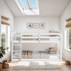 a white bunk bed sitting in a bedroom next to a window and potted plant