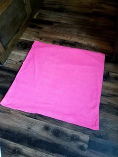 a pink towel is laying on the floor