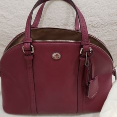 Never Wore Brand New But No Tags Burgundy Color Coach Burgundy Bag With Zipper Closure, Burgundy Top Handle Bag With Zipper Closure, Burgundy Top Handle Bag With Zipper, Coach Burgundy Tote Satchel, Coach Burgundy Satchel Bag, Coach Burgundy Satchel For Shopping, Burgundy Crossbody Satchel With Handles, Classic Burgundy Bag With Zipper Closure, Chic Burgundy Coach Bag