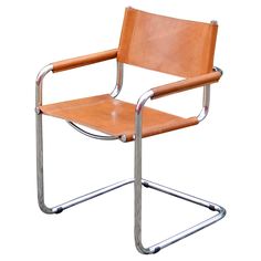 a tan leather chair with chrome frame and arm rests on an isolated white background,