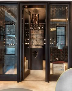 the inside of a wine cellar with glass doors